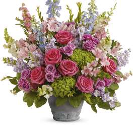 Mixed pink and lavender flowers in a gray pot