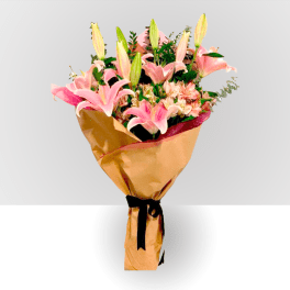 Bouquet of pink lilies and mixed flowers wrapped in gold paper