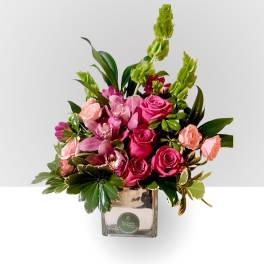Pink roses and orchids in a square glass vase