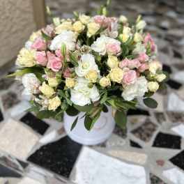 Bouquet of pink and cream roses in a white vase