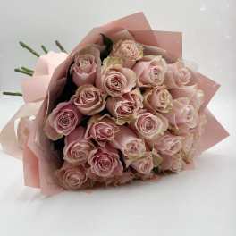 Bouquet of pale pink roses wrapped in pink paper