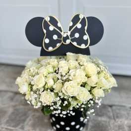 White rose bouquet in a black polka-dot vase with a Minnie Mouse topper