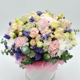 Mixed pastel bouquet in a round white box with pink tissue