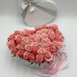 Heart-shaped box of pink roses with a ribbon bow