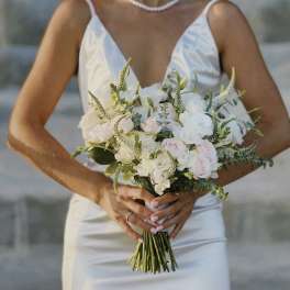 Bride holding a white and blush wedding bouquet