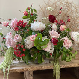 Mixed bouquet of pink and red roses in a low container