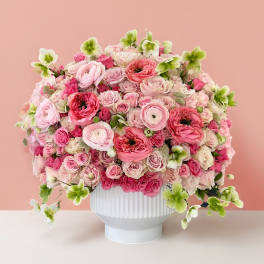 Pink and white flower arrangement in a white vase