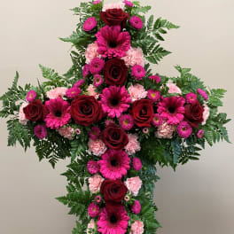 Large floral cross with red roses, pink gerberas, and carnations