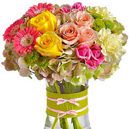 Mixed bouquet of roses and gerbera daisies in a glass vase