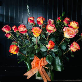 Bouquet of red and yellow roses with an orange ribbon