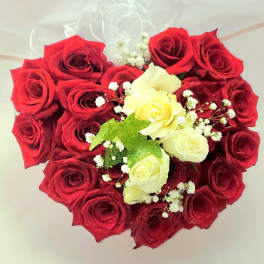Heart-shaped bouquet of red and white roses with baby's breath