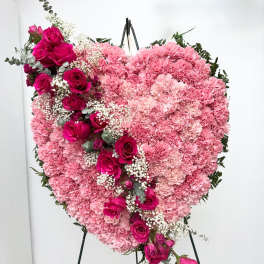 Heart-shaped pink floral standing arrangement with roses and carnations
