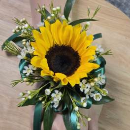 Sunflower wrist corsage with white filler flowers and teal ribbon