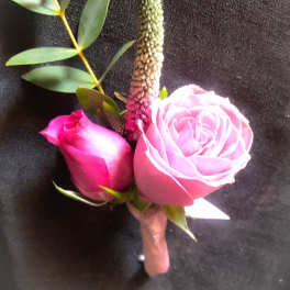 Pink rose boutonniere with eucalyptus and a tall green spike