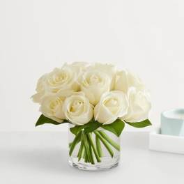 White rose bouquet in a clear glass vase