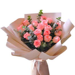 Bouquet of pink roses wrapped in blush paper