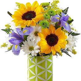 Bouquet of sunflowers, white daisies, and purple irises in a patterned vase