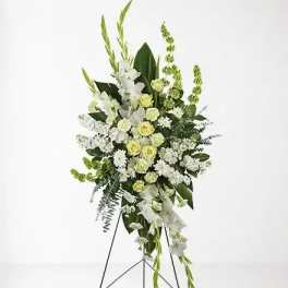 Tall white and pale green floral standing spray on an easel