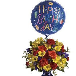 Birthday balloon above a colorful flower arrangement in a blue vase