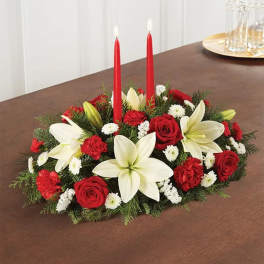 Red and white floral centerpiece with two red candles