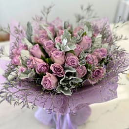 Lavender rose bouquet with silvery foliage and purple filler flowers