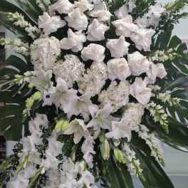 Large white floral standing spray with lilies and hydrangeas