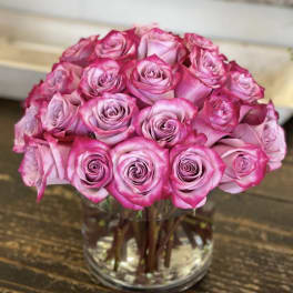 Pink roses arranged in a clear glass vase