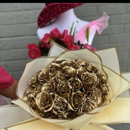 Bouquet of metallic gold roses wrapped in cream paper