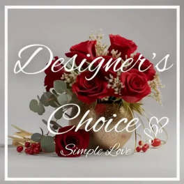 Red roses arranged in a gold vase with white filler flowers