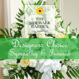 White floral sympathy arrangement with roses and lilies