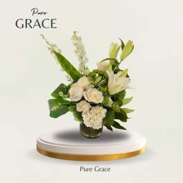 White roses and lilies arranged in a glass vase