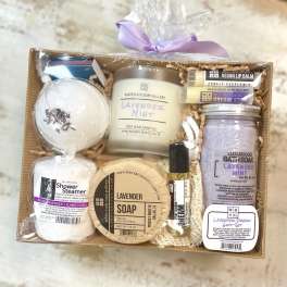 Lavender-themed gift basket with soap, candle, bath soak, and lip balm