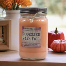 Orange candle in a mason jar with a fall label and twine tie