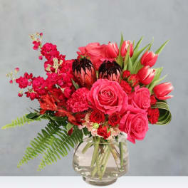 Pink and red mixed bouquet in a clear glass vase