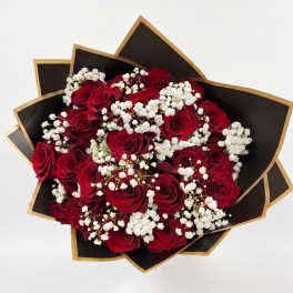 Bouquet of red roses with white baby's breath in black and gold wrap