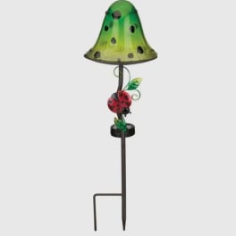 Green garden stake lamp with a ladybug decoration