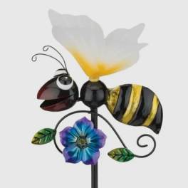 Decorative metal bee with a white flower and blue-purple blossom