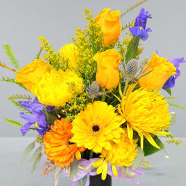 Bright yellow and purple mixed bouquet in a black vase