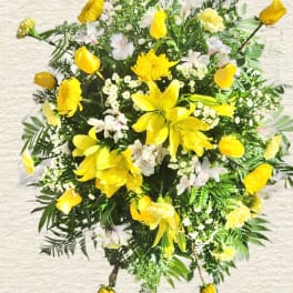 Yellow floral spray with lilies and mixed blooms