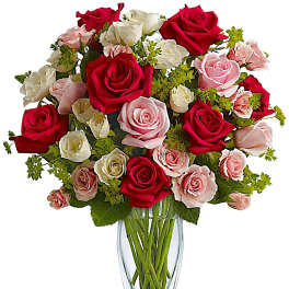 Bouquet of red, pink, and white roses in a clear glass vase