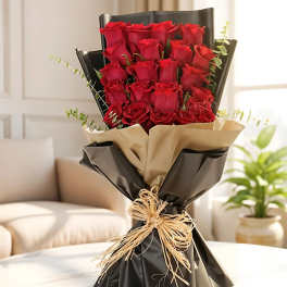Bouquet of red roses wrapped in black and beige paper