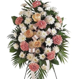 Standing floral spray with pink carnations, white daisies, and peach roses