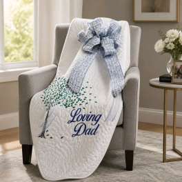 White memorial blanket with blue bow draped over a chair