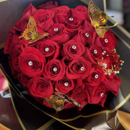Bouquet of red roses with gold butterfly decorations and rhinestones