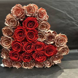 Heart-shaped bouquet of red and rose-gold roses
