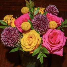 Bouquet of pink and yellow roses with purple allium blooms