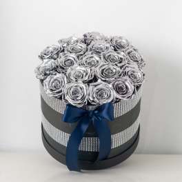 Round box of metallic silver roses in a black hatbox wrapped with rhinestones and a navy satin bow