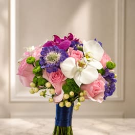 Wedding bouquet with pink roses, white orchids, and purple blooms