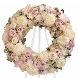 Pastel floral wreath on a white stand