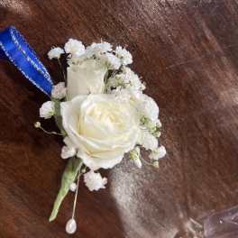 White rose boutonniere with baby's breath and blue ribbon